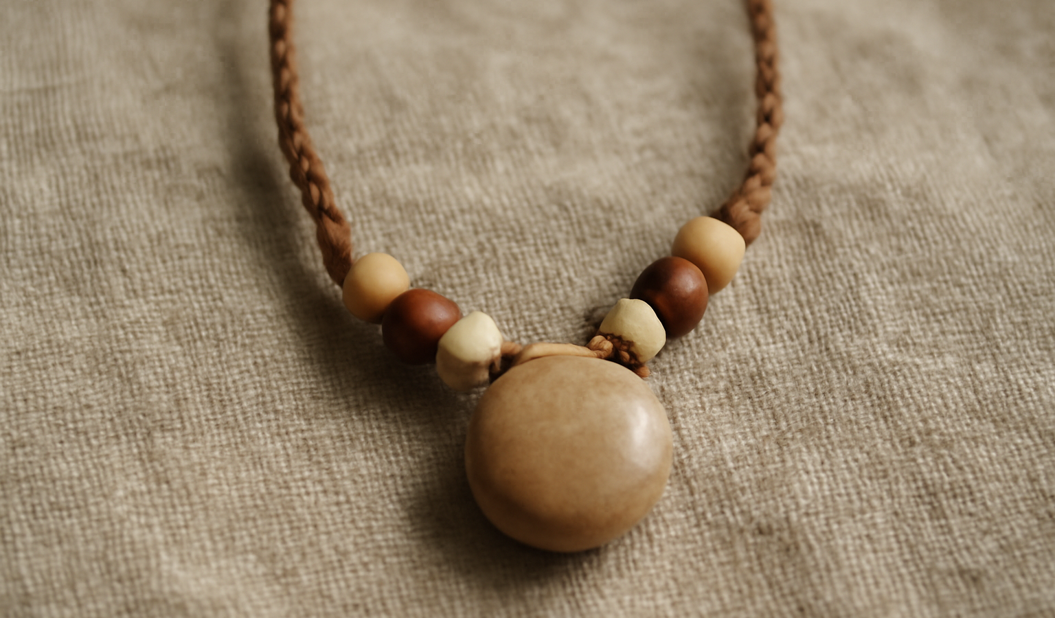 collier artisanal posé sur tissu